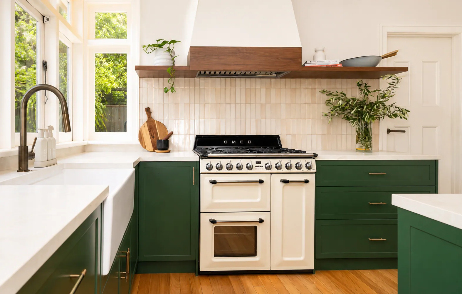 Green cabinetry and a freestanding cooker in a Kiely Group kitchen